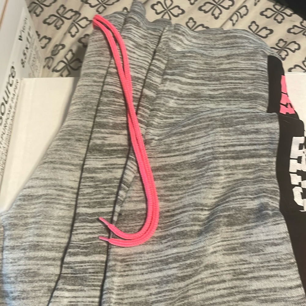 Grey sweatpants with the word love on the side